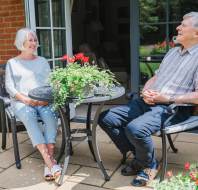 Owners relaxing in their garden