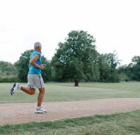 Older man running in park