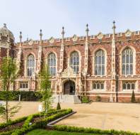 Exterior of Binswood Hall in Leamington Spa. Tudor styled red brick building with large windows.