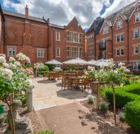 A terrace surrounded on 3 sides by a building