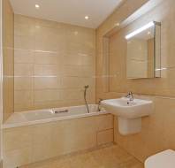 Modern bathroom with pale tiles