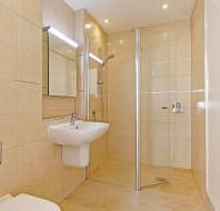 Shower room with pale tiles
