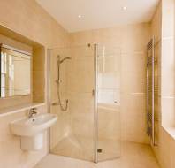 Shower room with pale tiles