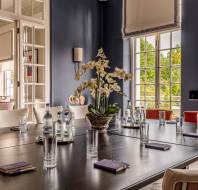 Seats at a large table in Georgian-style dining room