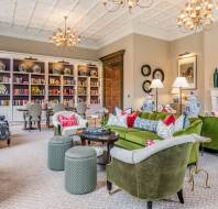 Library with soft seating and white bookshelves