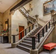 Sweeping stone staircase in mansion house