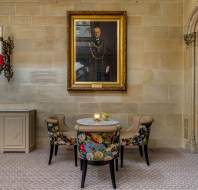 Comfortable seating in stone hallway with painting