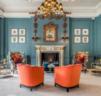 Lounge with chandelier and large fireplace