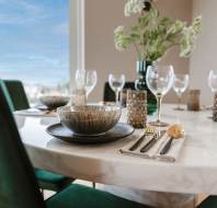 Marble table set for dinner by window