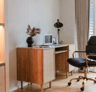 Desk with laptop and chair on castors