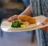 Owner with a plate of food at an event