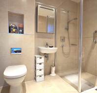 Modern bathroom with beige tiles, featuring a toilet, small sink, mirrored cabinet, and glass-enclosed shower. A small storage unit with drawers and a toilet paper holder are present.