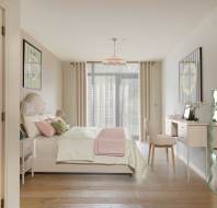 Bright bedroom with a neatly made bed, a vanity, a large wavy mirror, and a glass door leading outside. Decor includes pastel colors and framed artwork.