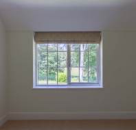 Bedroom interior with a window looking into the garden