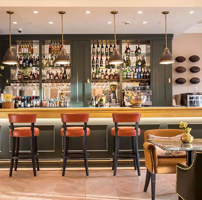 Well-lit bar with stools and polished fittings