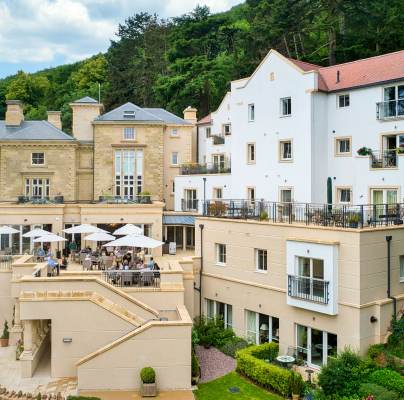 Stone building with apartments and restaurant terrace