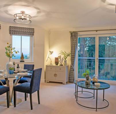 Bright living room with french doors and dining area