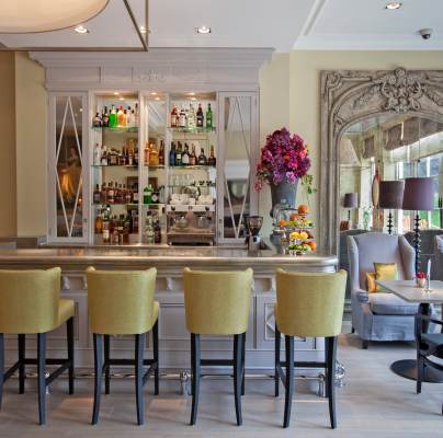 Stools at an immaculate, sunlit bar