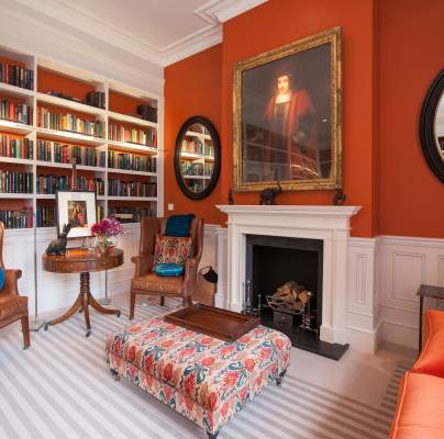 Luxury lounge with bookshelves and large fireplace