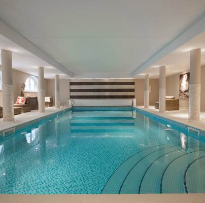 View along indoor pool with mosaic tiles