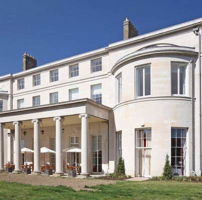 Pale stone mansion against a blue sky