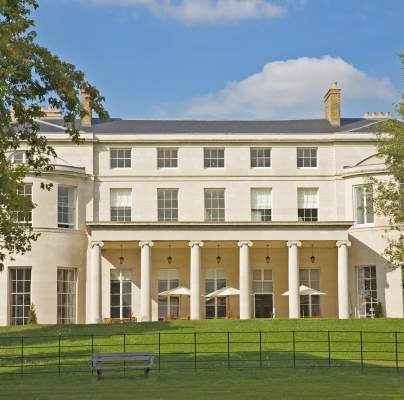 Grand pale-stone mansion with Ionic columns