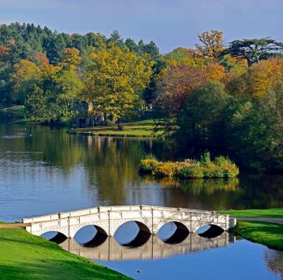Bridge over lake with autumn trees