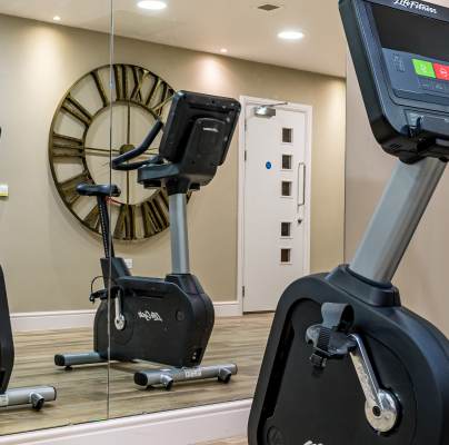 Gym equipment reflected in wall mirror