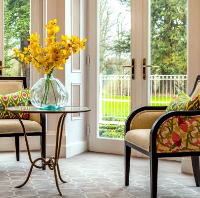 Chairs and table with flowers and garden view