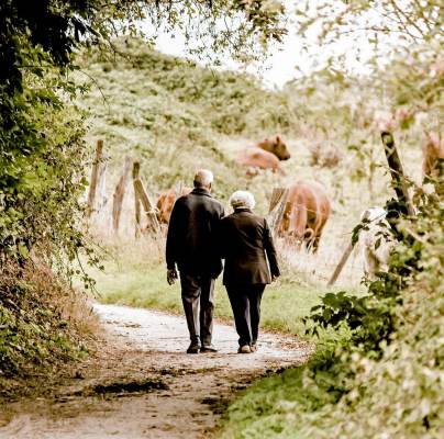 Senior couple walking in country lane