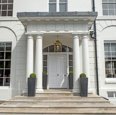 Covered entrance with pale stone steps