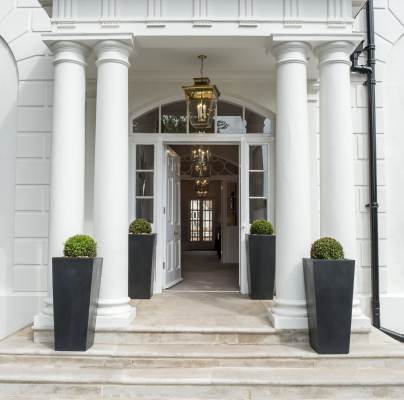 Covered entrance with columns and stone steps