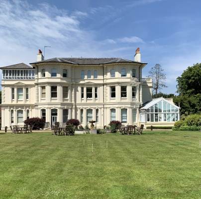 Mansion with lawn and croquet hoops