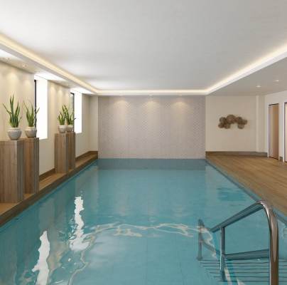 CGI of an indoor swimming pool with wood decking around