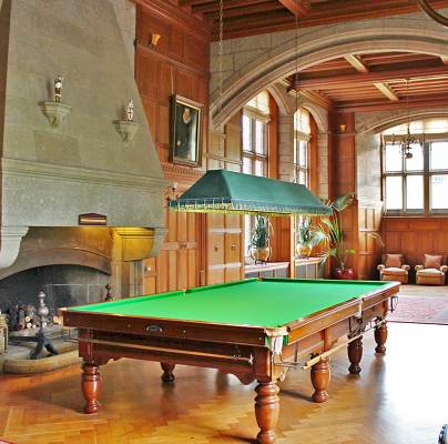 Green baize billiard table in grand panelled hall