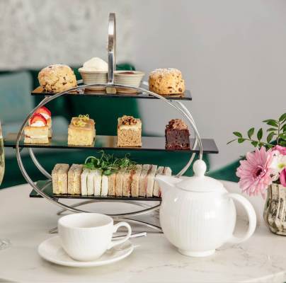 Afternoon Tea with sparkling wine, teapot and cake stand