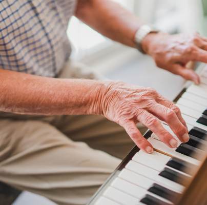 Aged hands playing piano