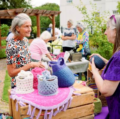 Customer talking with crochet stall owner