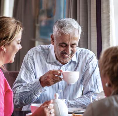 Couple enjoying tea with carer