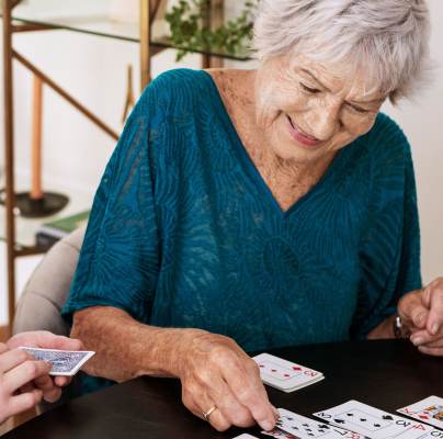 Woman and carer playing cards