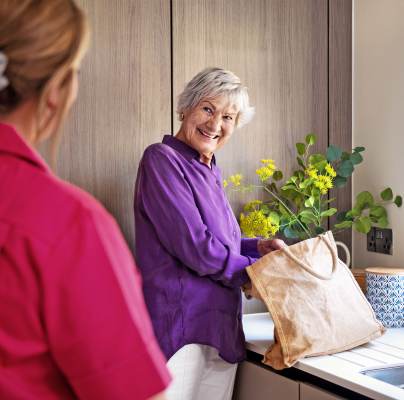 Carer helping woman with shopping