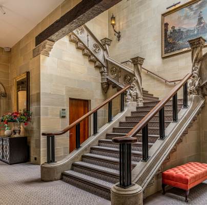 Sweeping stone staircase in mansion house