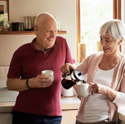 Seniors smiling and enjoying coffee together