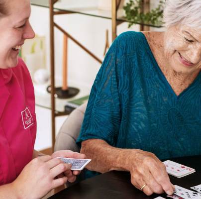 Woman playing cards with a carer