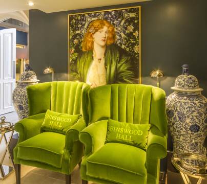 Comfortable green chairs, large pre-Raphaelite paintings and blue/white pots