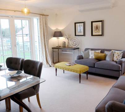 Lounge-diner in apartment with large windows