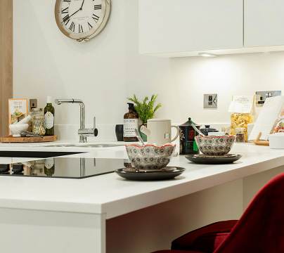 Two coffee cups on a white kitchen surface