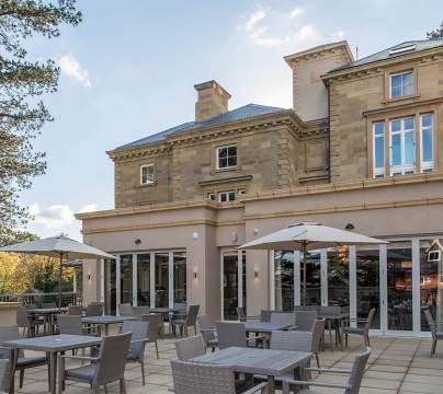 Restaurant terrace and pale-stone mansion