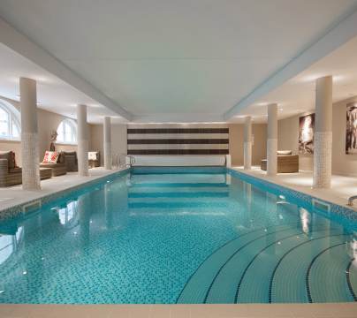 View along indoor pool with mosaic tiles