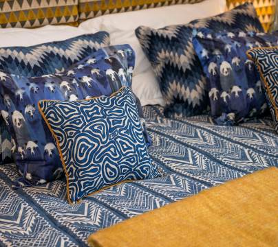 Bed with patterned throw and cushions
